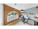 Bright home office features a large arched window with shutters and views of the lush landscaping at 11302 Crane Lake Ct, Riverview, FL 33569