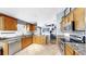 Bright kitchen with wood cabinetry, granite counters, and stainless steel appliances at 11302 Crane Lake Ct, Riverview, FL 33569