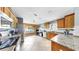 Open-concept kitchen boasts stainless steel appliances, granite counters, and seamless connection to the home office at 11302 Crane Lake Ct, Riverview, FL 33569