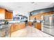 Open kitchen with wood cabinets, stainless steel appliances, and granite countertops at 11302 Crane Lake Ct, Riverview, FL 33569