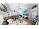 Relaxing living room with hardwood floors, leather sectional, and seamlessly connects to the dining room and kitchen at 11302 Crane Lake Ct, Riverview, FL 33569