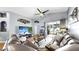 Cozy living room with a comfortable leather sectional, large screen TV, and sliding glass doors to the pool at 11302 Crane Lake Ct, Riverview, FL 33569