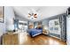 Serene main bedroom with a ceiling fan, sliding doors to the backyard, and a large window for ample natural light at 11302 Crane Lake Ct, Riverview, FL 33569