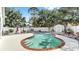 Enjoy the privacy of a refreshing kidney-shaped pool set against a backdrop of a white fence and mature trees at 11302 Crane Lake Ct, Riverview, FL 33569