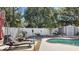 Relaxing poolside lounge area with two lounge chairs next to the pool at 11302 Crane Lake Ct, Riverview, FL 33569