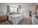 Stylish bedroom boasts ample natural light, a woven pendant light fixture, and ensuite bath access at 1203 E 33Rd Ave, Tampa, FL 33603