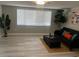 Bright living room with a large window, sleek flooring, a dark-gray sofa, and stylish décor at 12415 Stagecoach Ln, Hudson, FL 34667