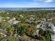 Aerial view with a red map marker over a neighborhood with tree coverage and the ocean in the distance at 132 21St S Ave, St Petersburg, FL 33705