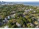 An aerial view of a lush, green neighborhood with a cityscape and ocean in the distance at 132 21St S Ave, St Petersburg, FL 33705