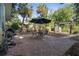 Spacious backyard features a brick patio, dining set under an umbrella, a grill, and a garden pergola at 132 21St S Ave, St Petersburg, FL 33705
