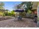 Inviting backyard patio features a dining set under an umbrella, a grill, and a view of lush landscaping at 132 21St S Ave, St Petersburg, FL 33705