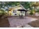 Charming backyard with a brick patio, dining set, grill, and shady trees, creating an outdoor oasis at 132 21St S Ave, St Petersburg, FL 33705