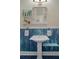 This bathroom's sink features a unique vintage style, bright light fixture, and shelving at 132 21St S Ave, St Petersburg, FL 33705