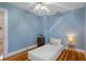Bright blue bedroom featuring hardwood floors, a ceiling fan and two windows for ample natural light at 132 21St S Ave, St Petersburg, FL 33705