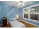This light blue bedroom has hardwood floors, ceiling fan, and large windows for lots of natural light at 132 21St S Ave, St Petersburg, FL 33705