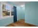 This light blue bedroom features hardwood floors, window and blue curtains at 132 21St S Ave, St Petersburg, FL 33705