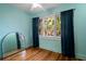 The hardwood floors and light blue walls are highlighted by a large window with blue curtains at 132 21St S Ave, St Petersburg, FL 33705