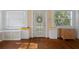 Bright entryway with hardwood floors, decorative brick accents, and natural light streaming through the windows at 132 21St S Ave, St Petersburg, FL 33705