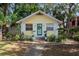 Charming yellow house featuring a quaint teal front door and a welcoming wreath at 132 21St S Ave, St Petersburg, FL 33705