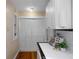 Pristine kitchen with white tiled countertops and appliances, complemented by hardwood floors at 132 21St S Ave, St Petersburg, FL 33705