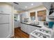 Bright kitchen featuring white appliances, ample counter space, and hardwood floors at 132 21St S Ave, St Petersburg, FL 33705