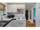 Efficient kitchen layout with updated appliances, white cabinets, and sleek black countertops at 132 21St S Ave, St Petersburg, FL 33705