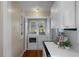 Bright laundry room with front loading washer and dryer, shelving and storage near the kitchen area at 132 21St S Ave, St Petersburg, FL 33705