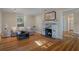 Cozy living room featuring hardwood floors, a brick fireplace, and a comfortable sofa with decorative pillows at 132 21St S Ave, St Petersburg, FL 33705