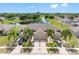 Beautiful home boasts three-car garage, lush landscaping, pond view, and convenient street access at 13313 Ashbark Ct, Riverview, FL 33579