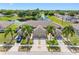 A Stunning aerial view of a home with a three car garage, beautiful landscaping and a serene pond at 13313 Ashbark Ct, Riverview, FL 33579