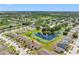 A sprawling residential community features beautiful homes situated around a central lake, perfect for families at 13313 Ashbark Ct, Riverview, FL 33579