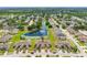 A beautifully landscaped home overlooks a serene pond in a neighborhood with tree-lined streets at 13313 Ashbark Ct, Riverview, FL 33579