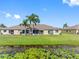 Beautiful home featuring a spacious backyard and screened lanai overlooking a serene pond view at 13313 Ashbark Ct, Riverview, FL 33579