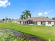 A spacious backyard with a screened lanai overlooks a serene pond, perfect for relaxation and enjoying nature at 13313 Ashbark Ct, Riverview, FL 33579