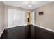 A bedroom featuring hardwood floors, a modern chandelier and a closet with bifold doors at 13313 Ashbark Ct, Riverview, FL 33579