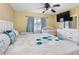 A Primary bedroom has a queen bed, ceiling fan, and a Bedroom corner with white crib at 13313 Ashbark Ct, Riverview, FL 33579