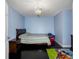 A bedroom painted light blue features a bed and cartoon carpet at 13313 Ashbark Ct, Riverview, FL 33579