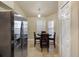 A breakfast nook features stainless refrigerator, wood table, and is naturally lit by a window at 13313 Ashbark Ct, Riverview, FL 33579