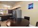 A full kitchen featuring stainless appliances overlooks a breakfast nook with door to the home at 13313 Ashbark Ct, Riverview, FL 33579