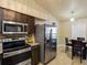 The eat-in kitchen features granite counters, stainless appliances, breakfast nook with door to the home at 13313 Ashbark Ct, Riverview, FL 33579