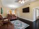 Open living room boasts dark wood floors, fan, and stylish furniture, with view of dining area and kitchen at 13313 Ashbark Ct, Riverview, FL 33579