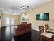 Spacious living room featuring dark wood floors, stylish furniture, ceiling fan, and elegant decor at 13313 Ashbark Ct, Riverview, FL 33579