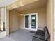 Covered patio with neutral concrete, lighting, and outdoor furniture overlooking the landscape at 13313 Ashbark Ct, Riverview, FL 33579