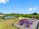 Community playground with colorful play structures and ample green space at 13313 Ashbark Ct, Riverview, FL 33579