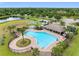 Community pool with lounge area, shade and basketball court at 13313 Ashbark Ct, Riverview, FL 33579