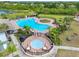 Aerial view of a community pool with a hot tub, lounge area and playground at 13313 Ashbark Ct, Riverview, FL 33579