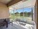 Screened patio with patio furniture and stunning views of the backyard lake at 13313 Ashbark Ct, Riverview, FL 33579