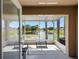 View from screened in patio with lake view and patio furniture perfect for outdoor relaxation at 13313 Ashbark Ct, Riverview, FL 33579