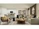Open-concept living room and kitchen featuring stylish seating, modern decor, and a cozy atmosphere at 15033 Zircon Red Dr, Wimauma, FL 33598