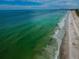 Expansive aerial view of the shoreline with crystal clear turquoise water and sandy beach at 1600 Gulf Blvd # 514, Clearwater Beach, FL 33767